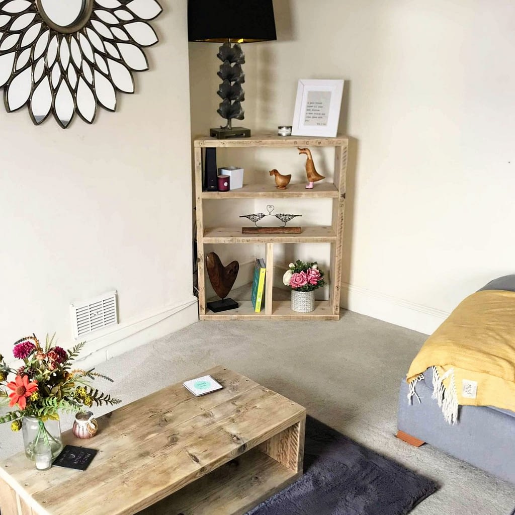 A rustic reclaimed timber bookcase with ornaments on