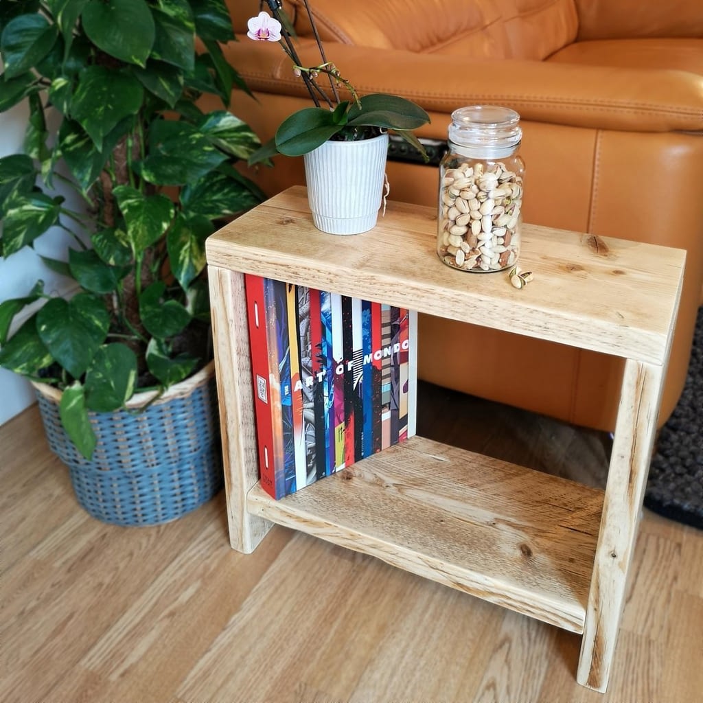 A reclaimed timber side table with an orchid on